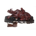 Chinese carved hardwood water buffalo with riding figure, on stand,