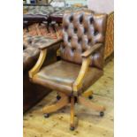 Tan buttoned leather swivel desk chair.