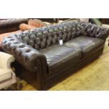Brown deep buttoned leather three seater Chesterfield settee.