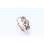 Three stone diamond set ring with platinum setting on 18 carat yellow gold shank, size L.