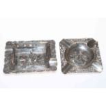 Two Dutch silver repousse ashtrays, embossed with figures and Inn scenes.