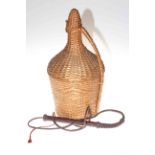 Large bottle in basket cover, 52cm and a leather plaited whip (2).