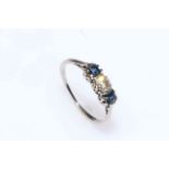 Diamond and sapphire three stone ring in 18 carat white gold, size T.