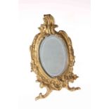 Ornate gilt easel photograph frame with bevelled glass.