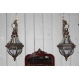 Pair of glass and metal hall lanterns with brackets.