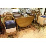 Oak drop leaf dining table and four wheelback dining chairs.