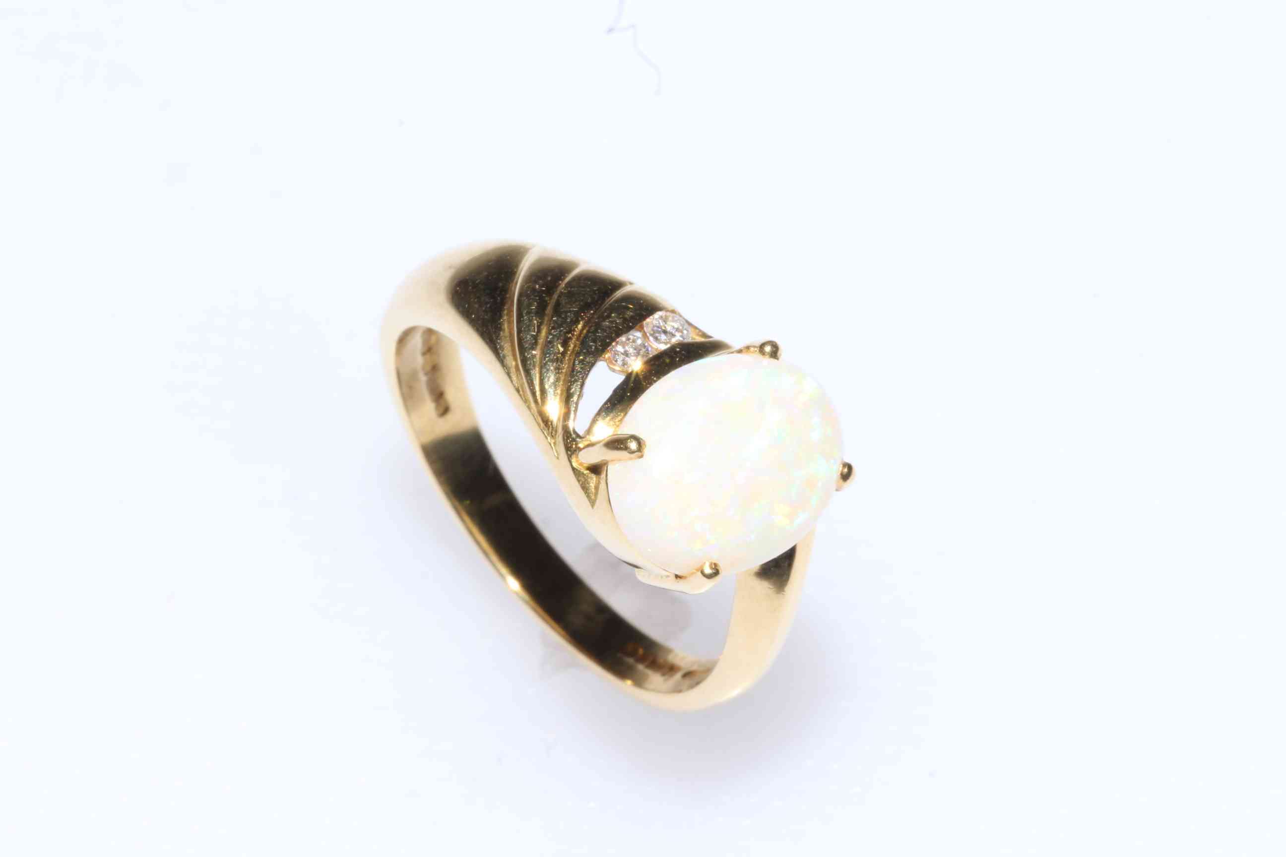 18 carat yellow gold, oval opal and diamond ring, size O.