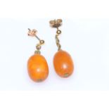 Pair of 9 carat yellow gold and amber drop earrings.