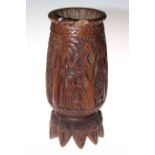 'South Sea' carved wood vase decorated with palm trees and on multiple head feet, 28cm.