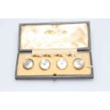 Cased set of 9 carat gold and mother of pearl buttons.