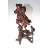 Antique Chinese root carving of figure on stand.