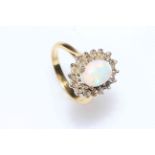 Opal and diamond cluster ring set in 18 carat yellow gold, size N.