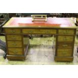 Victorian mahogany nine drawer pedestal desk with red tooled leather inset top, 74cm by 137cm.