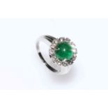 Impressive platinum, circular emerald and diamond cluster ring,