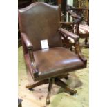 Brown studded leather swivel desk chair.