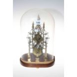 Small brass skeleton clock with fusee movement and mahogany stand under glass dome, 34cm.