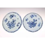 Pair of late 18th Century Chinese blue and white saucer dishes, painted with flowers, 22cm diameter.