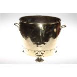 Highly polished brass two handled jardiniere raised on three paw feet.