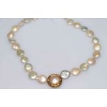 Cultured pearl necklace with 18 carat coin set single pearl.