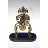 Brass skeleton clock with silvered dial, lacking dome.
