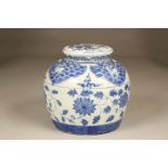 20th Century Chinese blue and white jar and cover with foliate decoration. 24cm high