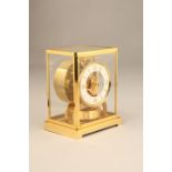 Jaeger Lecoultre Atmos clock, gilt brass case, white chapter ring with gilt numbers and hour batons,