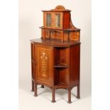 An Art Nouveau mahogany side cabinet, single door inlaid with stylised flowers flanked by open