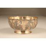 Chinese silver bowl, circular footed form, lobed rim and bowl decorated in floral and bird relief,