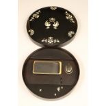 Japanese Suzuribako, black lacquered box, decorated with mother of pearl inlay. Circular form with