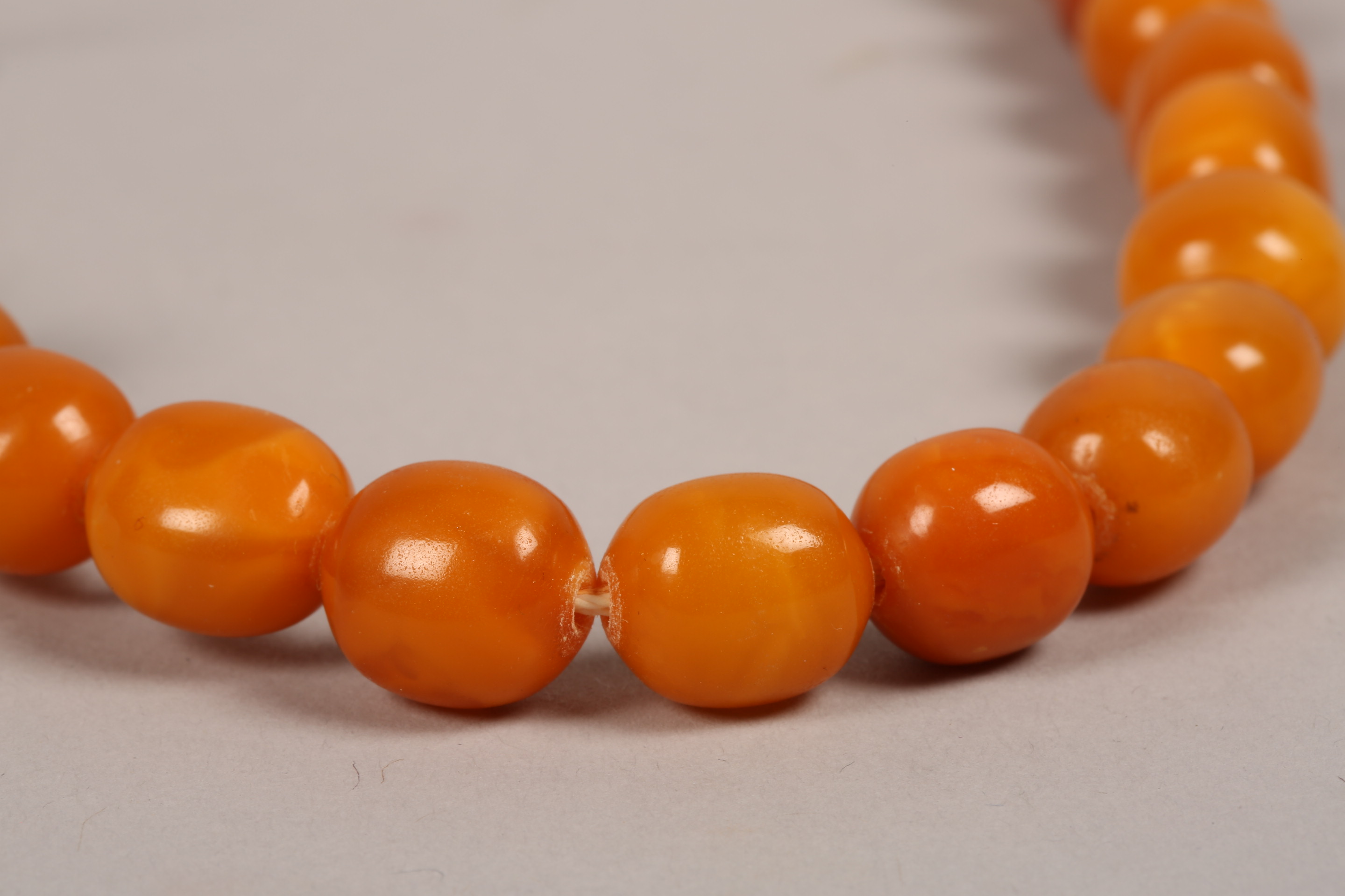 String of butterscotch amber beads. 64cm long, largest bead 20mm diameter - Image 5 of 7