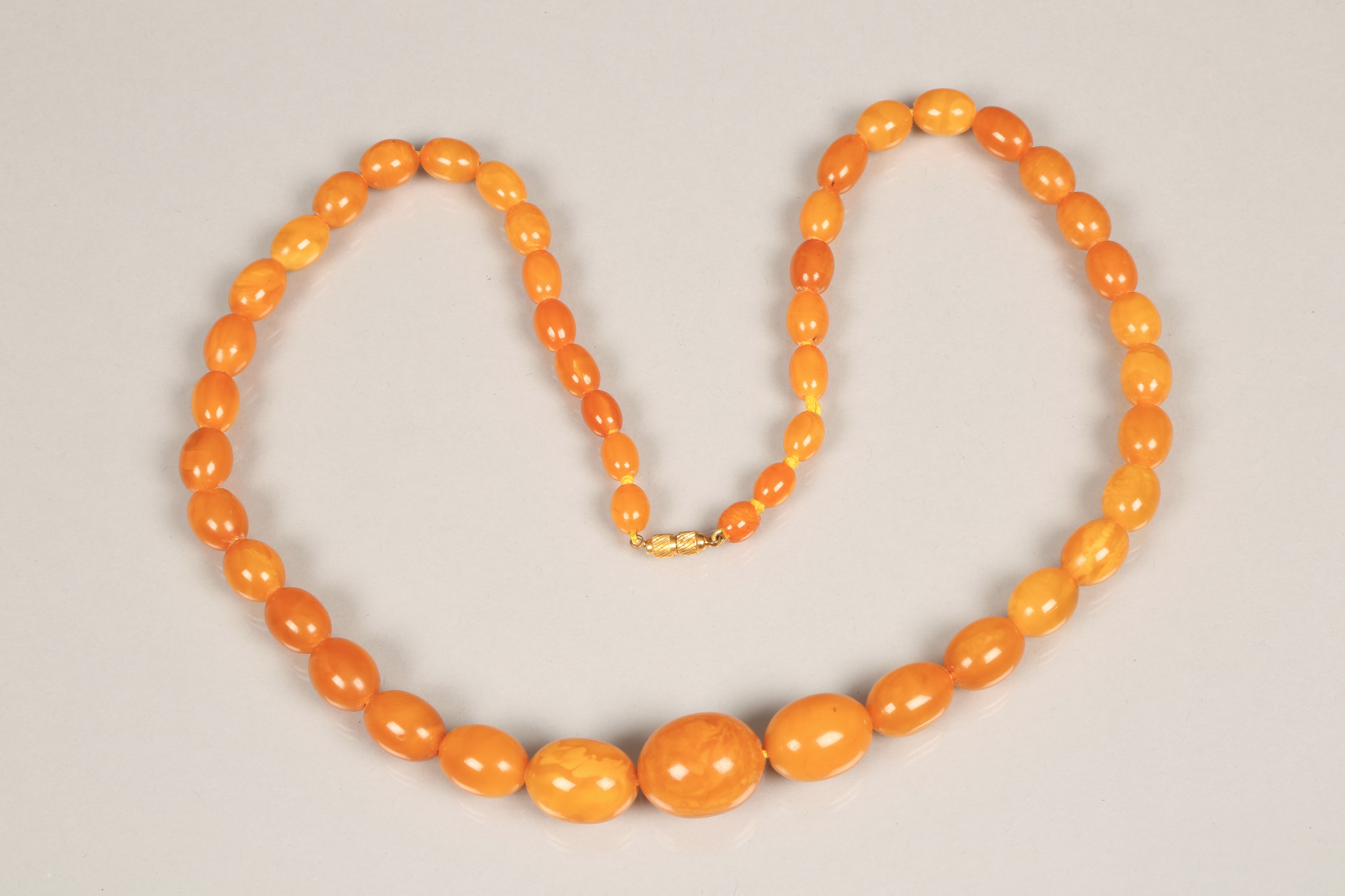 19th Century amber bead necklace (restrung) 69cm long, largest bead 20mm x 25mm. 53g