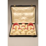 Cased Royal Worcester coffee set, 6 coffee cups with gilt interiors, 6 saucers, 6 silver gilt spoons