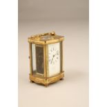 French brass carriage clock, serpentine shaped front and sides, white dial with Roman numerals,