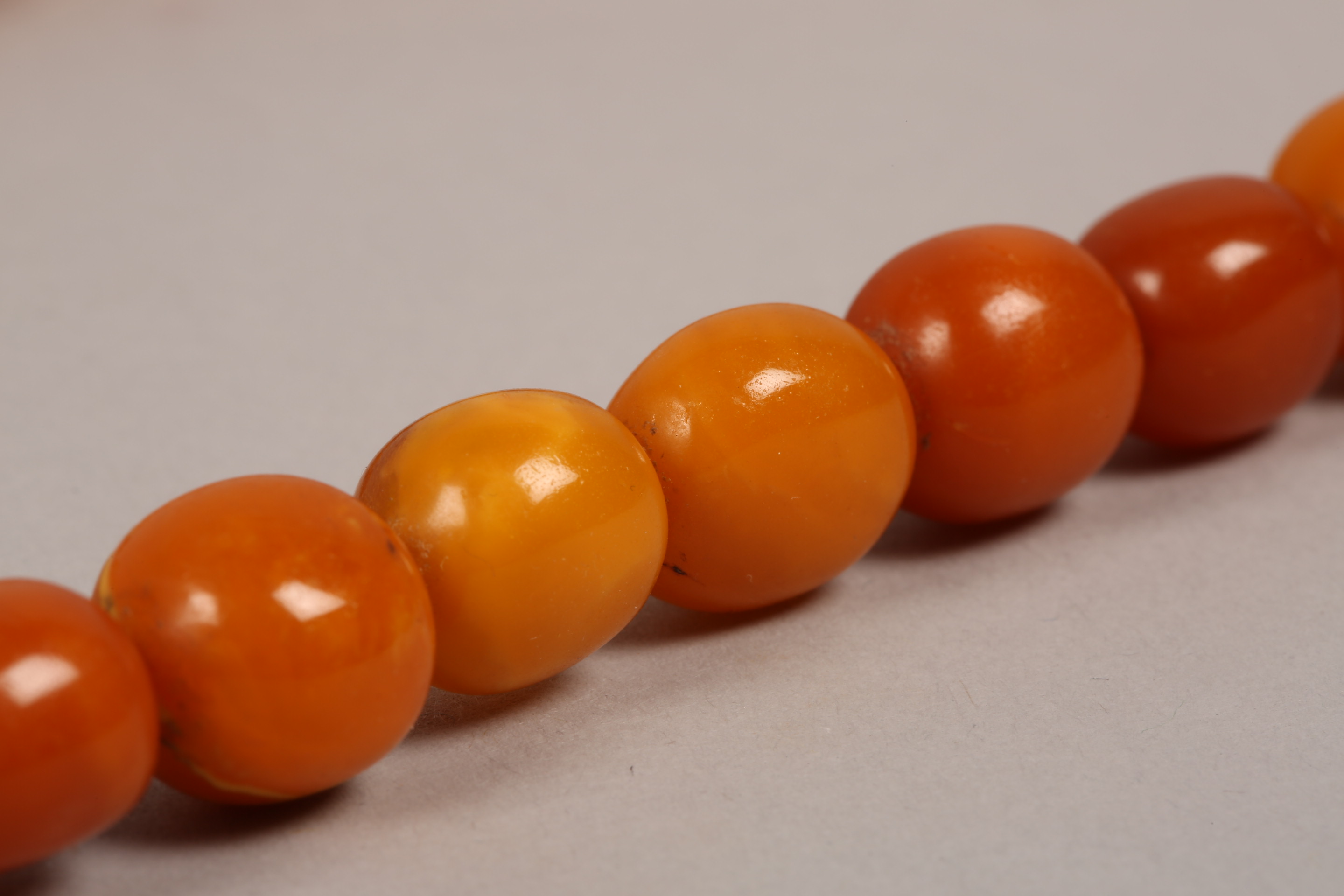 String of butterscotch amber beads. 64cm long, largest bead 20mm diameter - Image 4 of 7