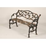 Victorian wrought iron garden seat, cast branches and leaves, 128cm long