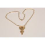 9 carat gold pendant and chain by Ola Gorie. Stylised zoomorphic pattern to the pendant