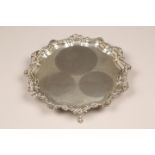 Edwardian silver salver, scallop shell and scroll border, raised on scroll feet. Assay marked