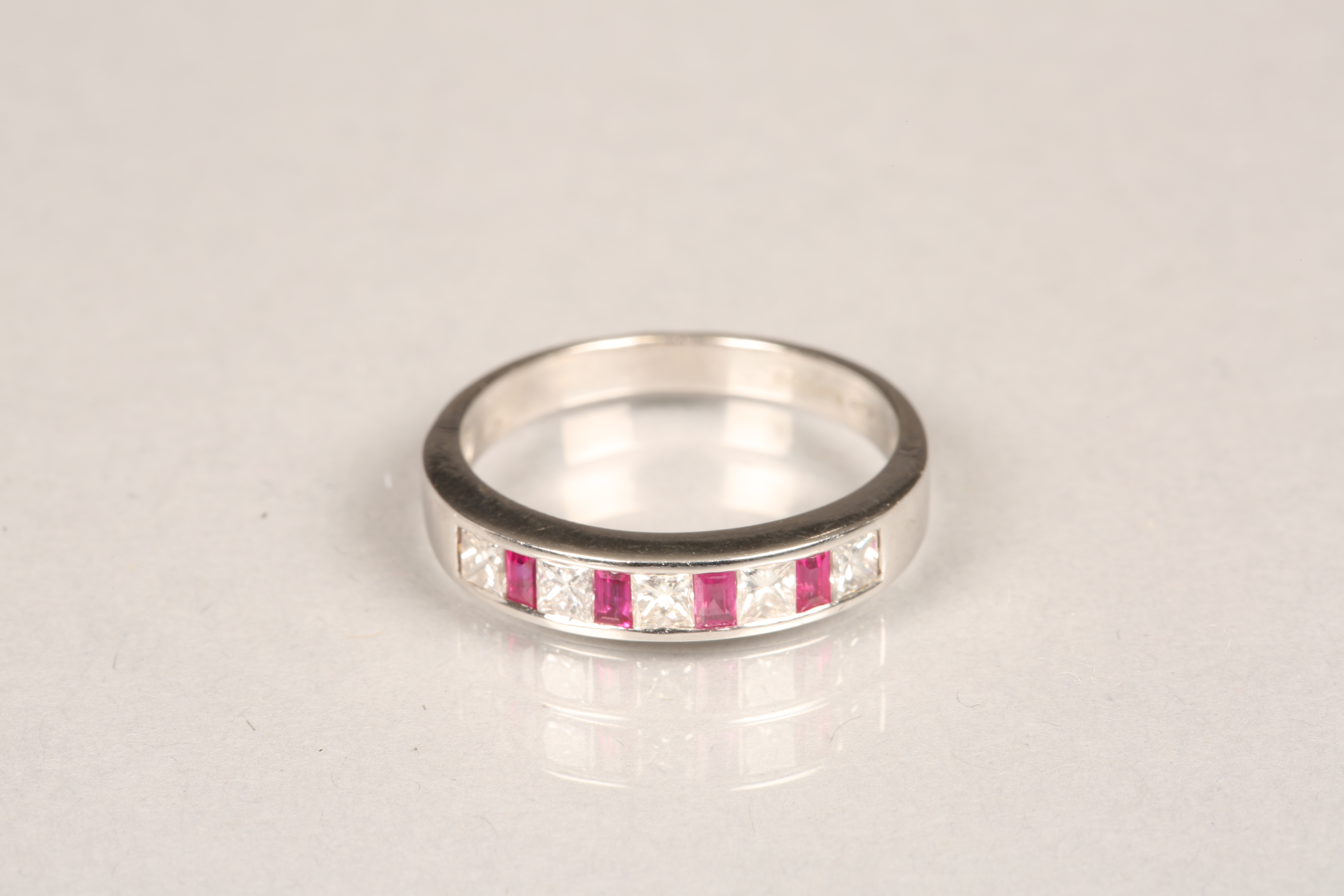 Ladies 18 carat white gold ruby and diamond eternity ring, five diamonds and four rubies. Ring