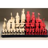 32 piece Eastern carved ivory chess set one side natural the other side stained red. There are