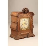 Continental oak cased mantel clock, square brass dial, silver chapter ring with black Roman