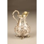 Victorian silver embossed cream jug with bulbous floral decoration, family crest engraved. Assay