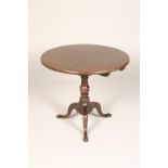 George III mahogany pedestal table, circular top, bird cage tip up, supported on a turned