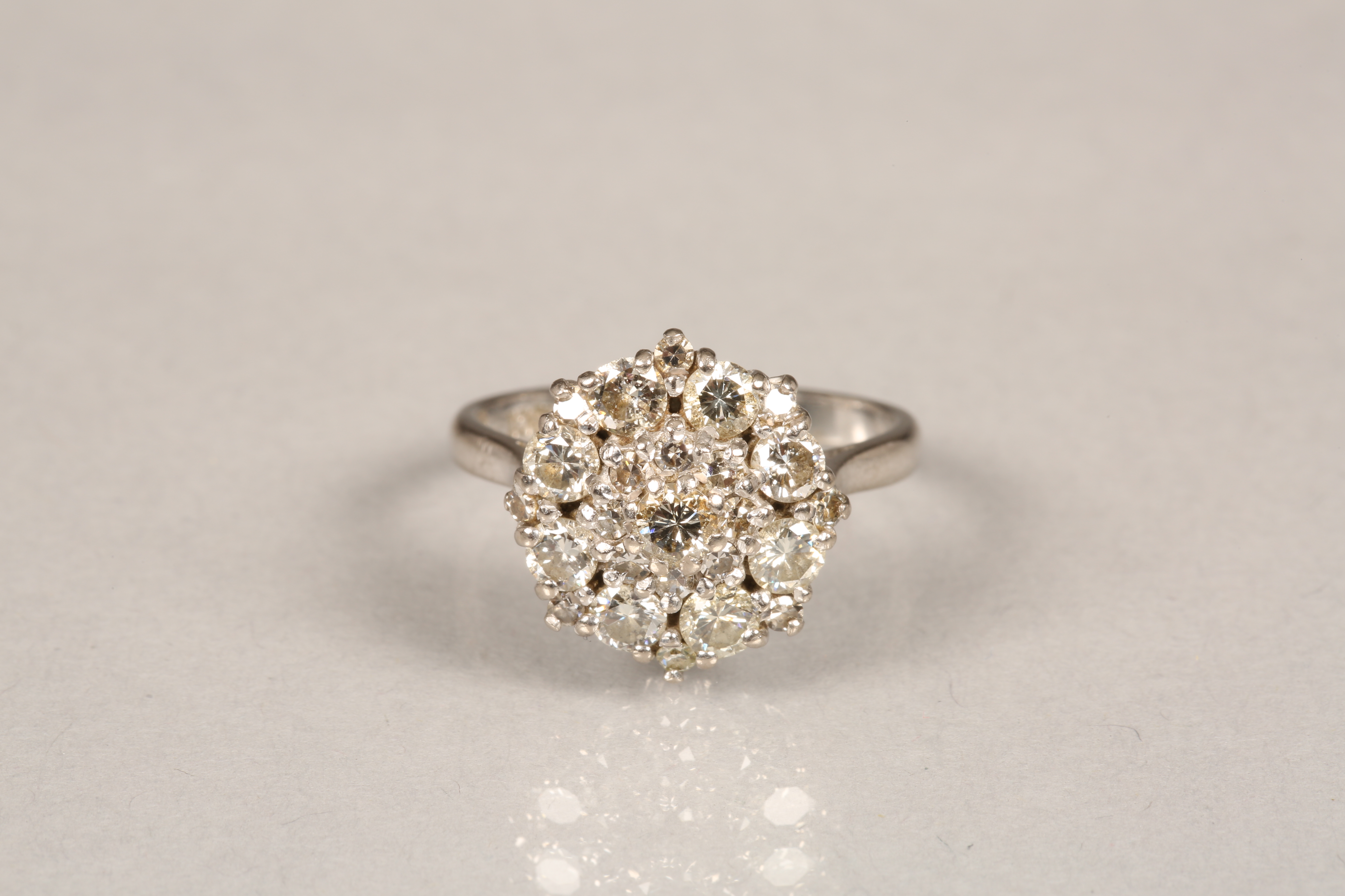 Ladies 18 carat white gold diamond cluster ring, brilliant cut diamonds in a round stepped