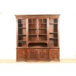19th/20th century oak breakfront bookcase four glazed doors over four small cupboard doors with