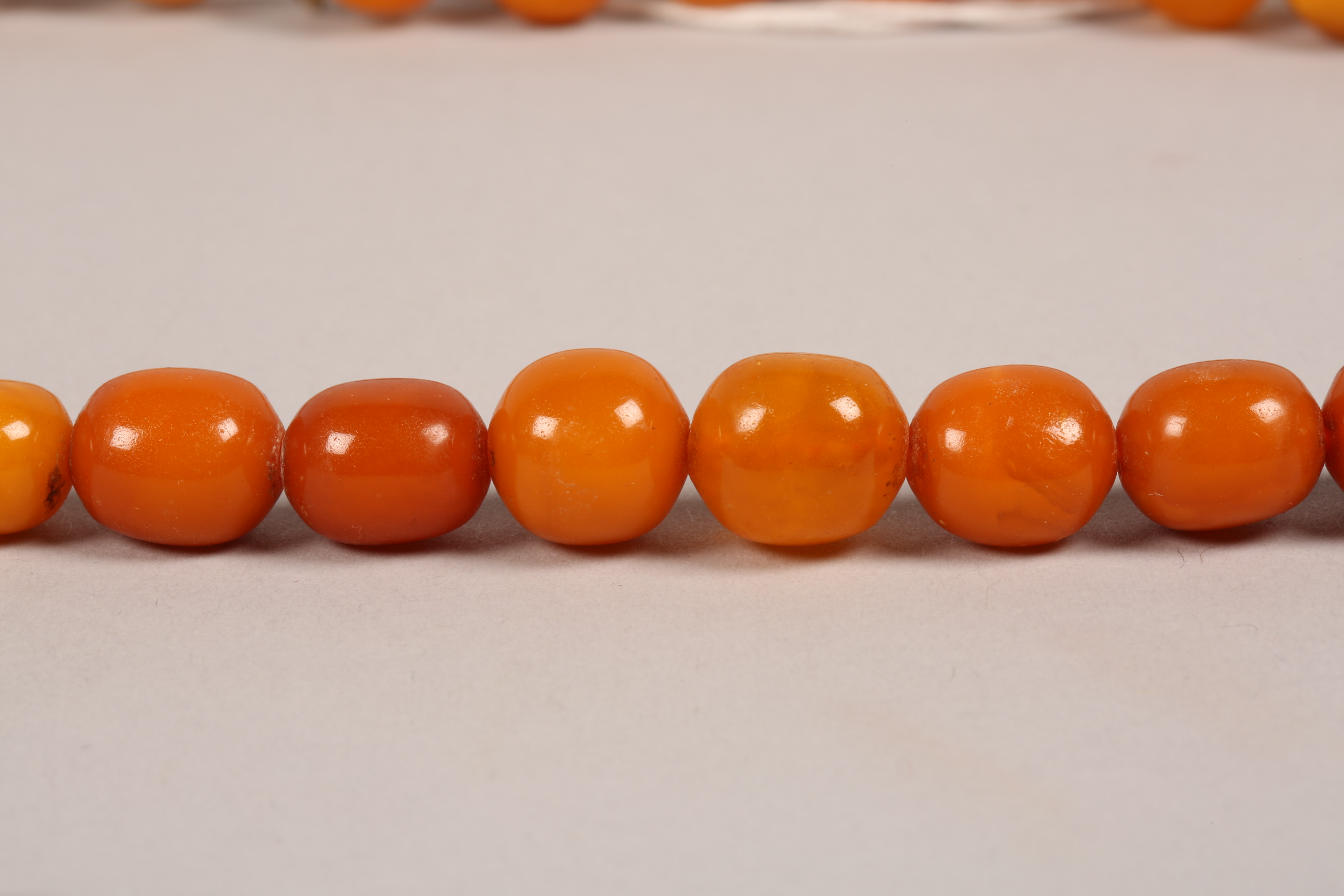 String of butterscotch amber beads. 64cm long, largest bead 20mm diameter - Image 3 of 7