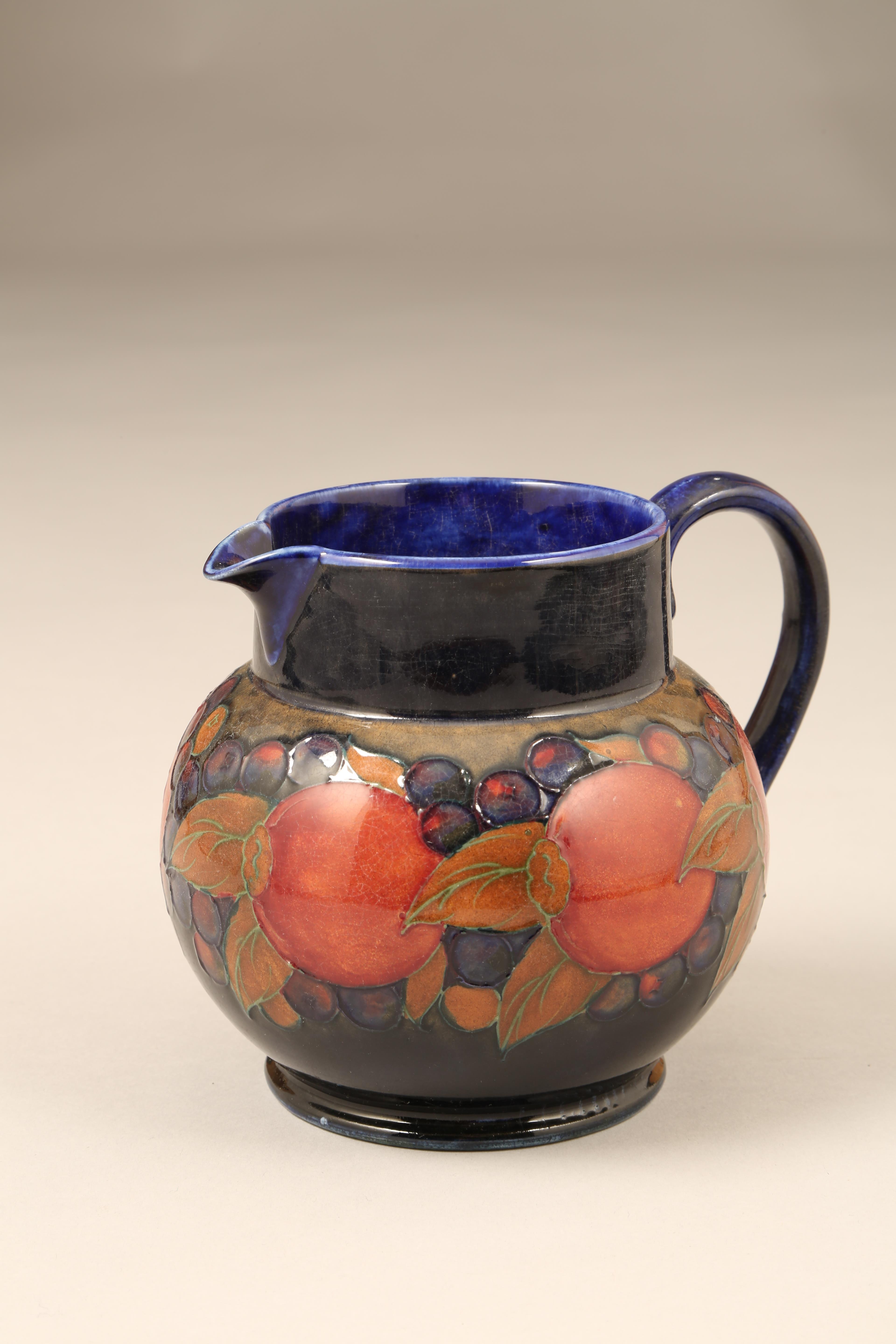 Moorcroft pottery jug, pomegranate pattern, signed and inscribed to base, 14cm high