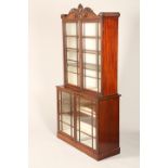 Regency style mahogany bookcase, carved and reeded cornice over twin glazed doors over a shelved