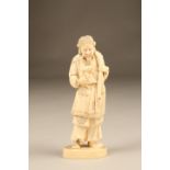 Japanese carved ivory figure, a man holding a rabbit signed to base, Meiji period. 19.5cm high