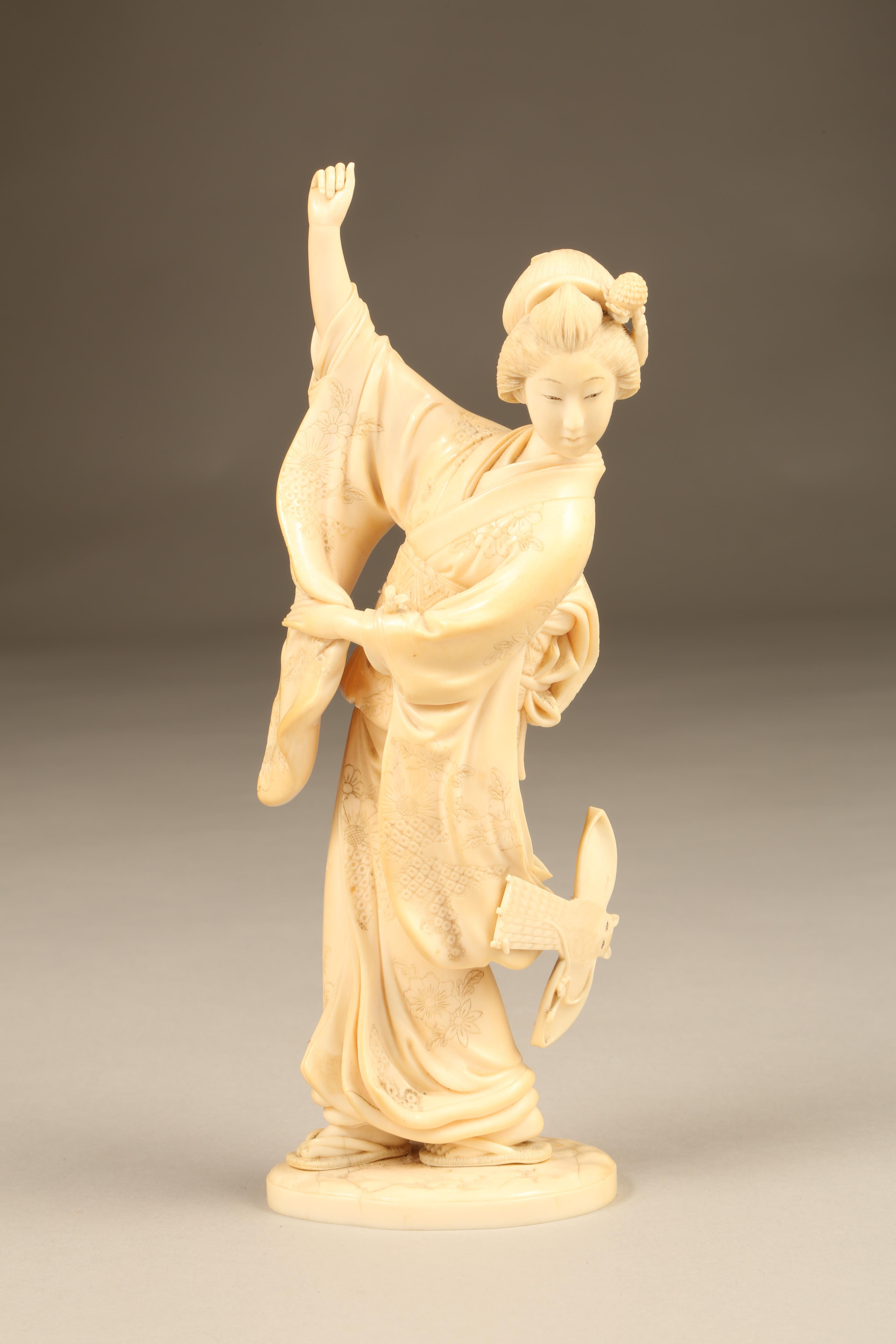 Japanese carved ivory figure, a dancing geisha girl signed to base, Meiji period. 19.5cm high