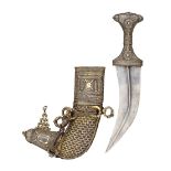 ‡ AN ARAB SILVER-MOUNTED DAGGER (JAMBIYA), LATE 19TH CENTURY with curved medially ridged double-